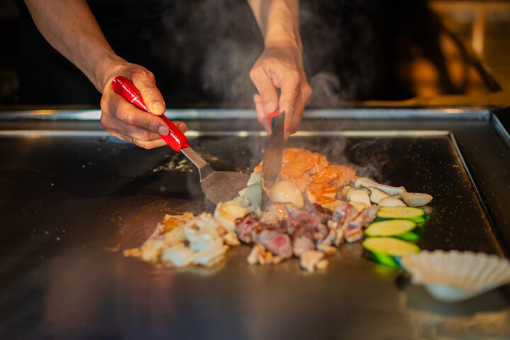 Hibachi chef performing cooking show at Boston party