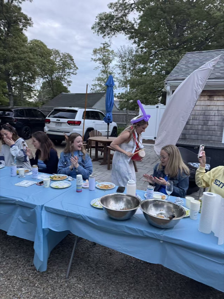 Guests enjoying a hibachi catering party at an outdoor table in New England