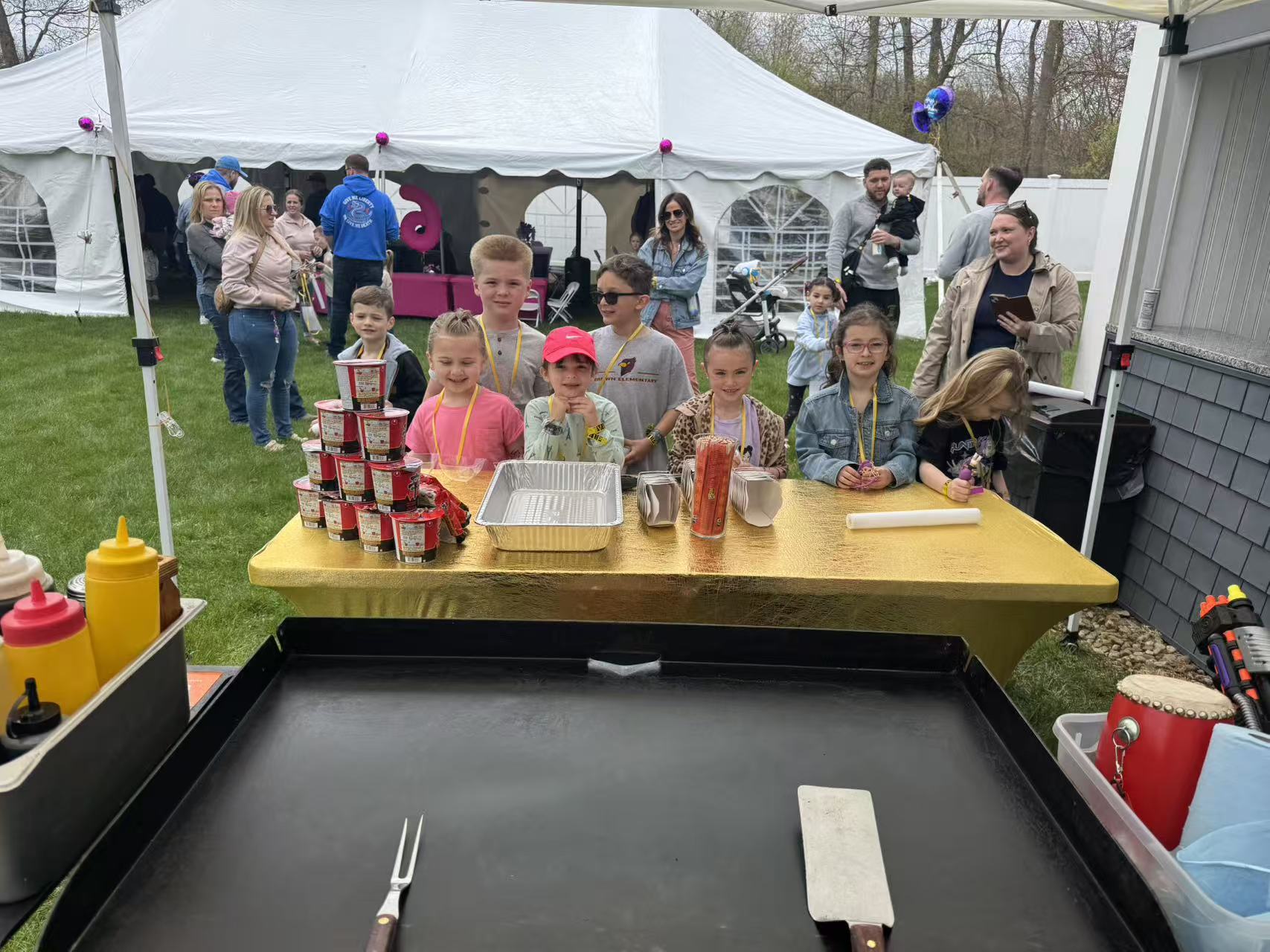 Kids gathered around mobile hibachi grill at New England outdoor event