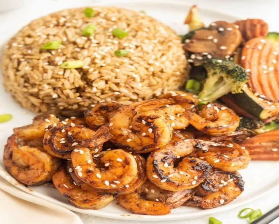 Hibachi fried rice and vegetables cooked on teppanyaki grill New England